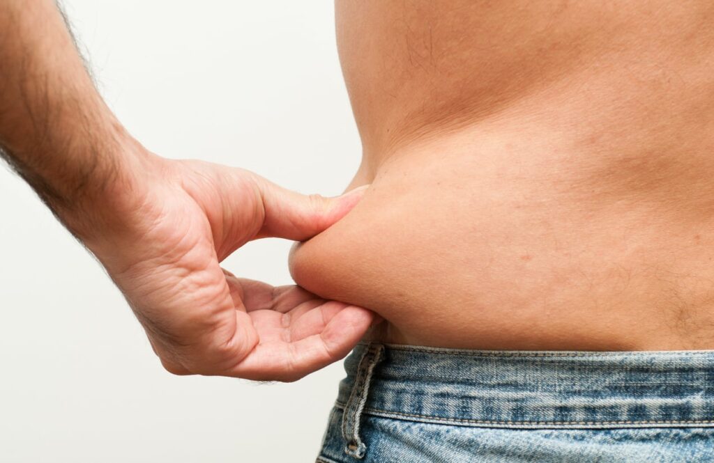 close up shot of men showing fat in his body.