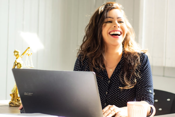 Beautiful Woman smiling behind desk