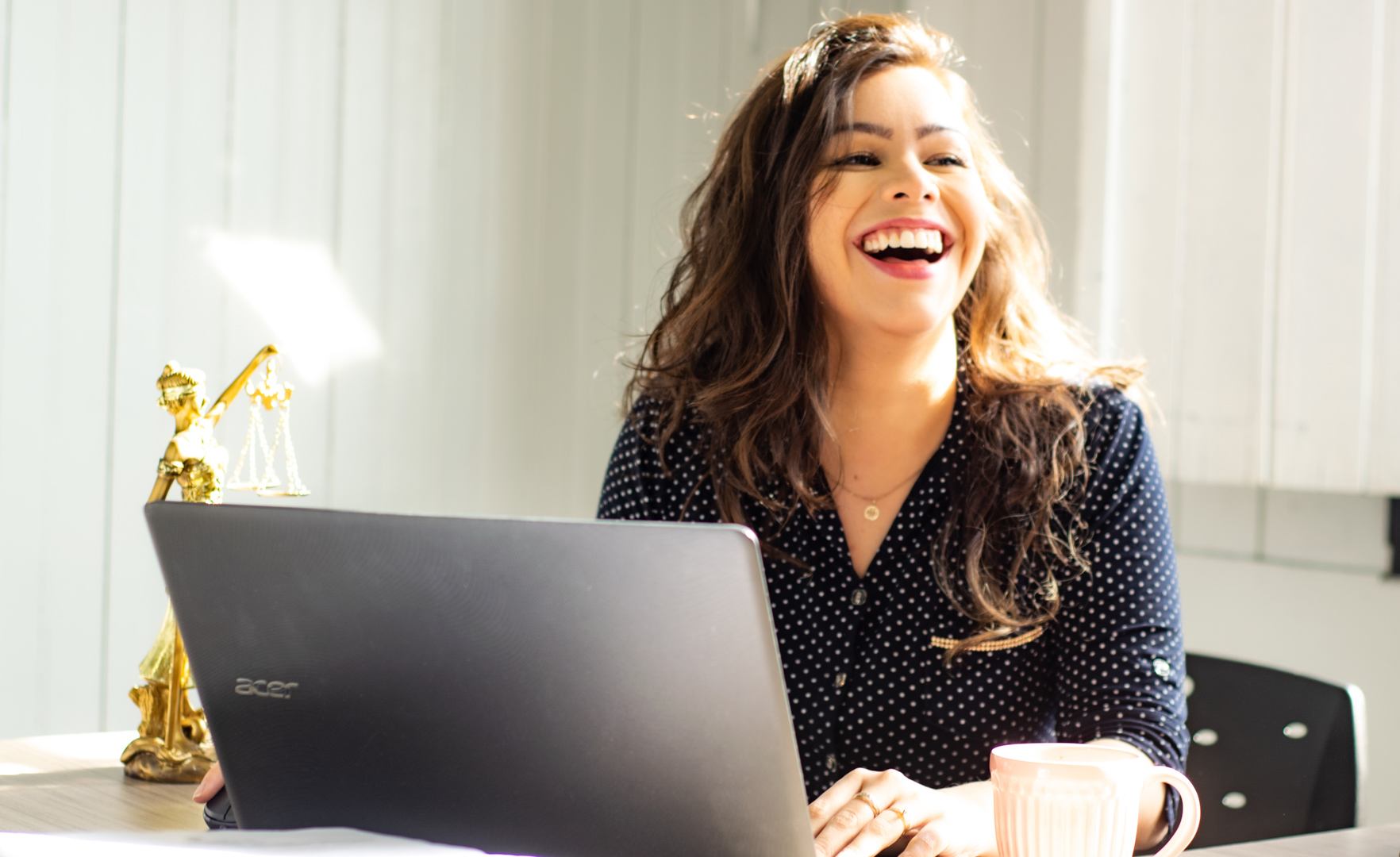Beautiful Woman smiling behind desk