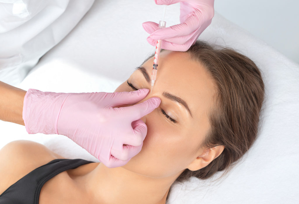 does botox prevent wrinkles Cosmetologist makes rejuvenating anti wrinkle injections on the face of a beautiful woman. Female aesthetic cosmetology in a beauty salon.
