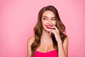 Close up photo amazing beautiful she her lady think over trick look sly side empty space hand arm white teeth wear cute shiny colorful dress isolated pink rose bright vivid background.