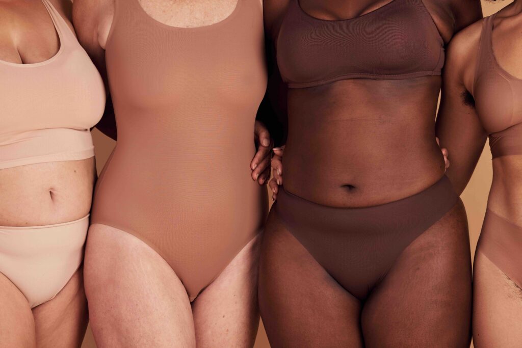 Diversity, women and skincare for body positivity, inclusivity and on brown studio background. Health females, freedom and multiracial ladies with confidence, wellness and healthy with empowerment