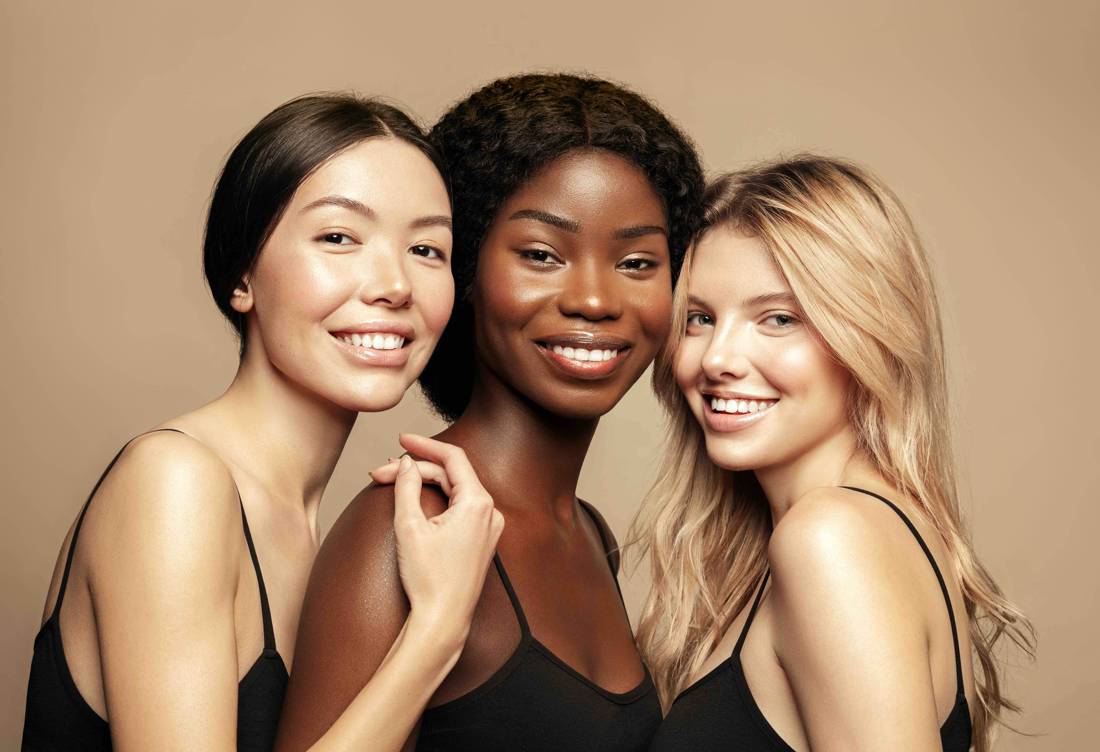 A group of women of different backgrounds smiling together